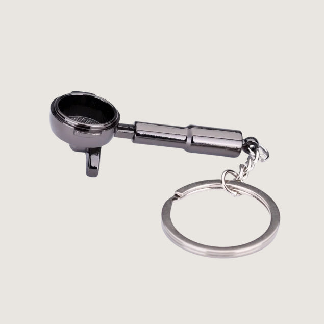 A sleek black portafilter keychain with a spouted design, crafted for coffee lovers and baristas who appreciate espresso-making essentials.